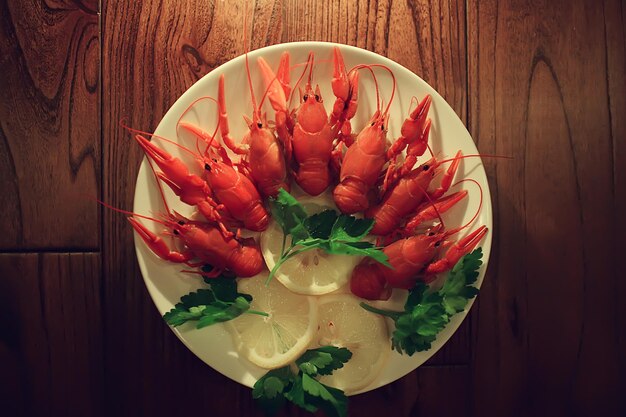 Boiled crayfish in a plate, red river arthropods, delicacy food\
diet seafood