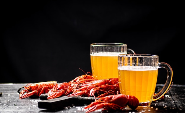 Boiled crayfish with beer on a cutting board