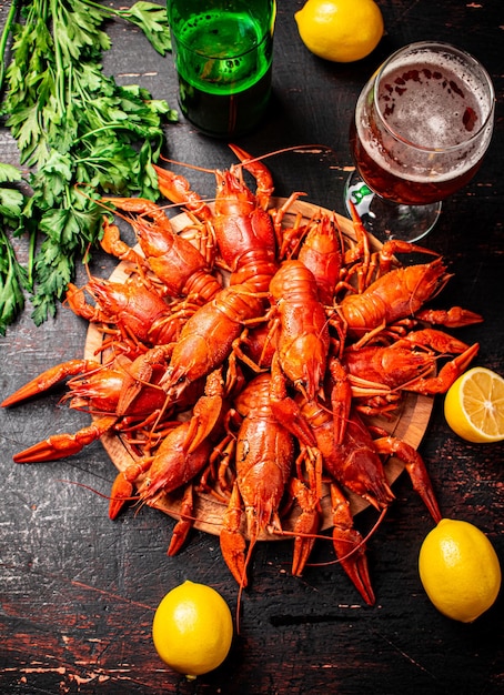 Boiled crayfish with a glass of beer and lemon