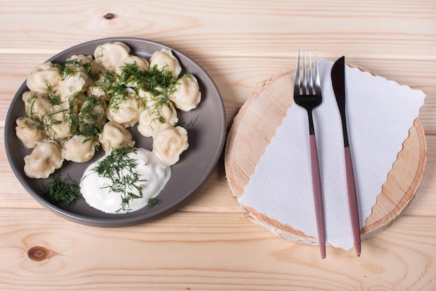 Boiled dumplings with dill and sour cream Homemade dumplings with meat