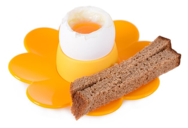 Boiled egg in egg cup isolated on white