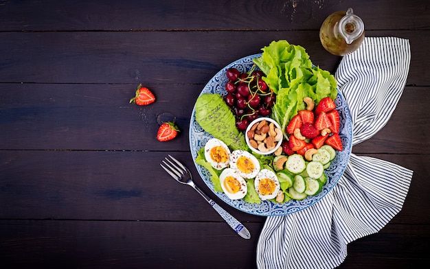 Boiled eggs, avocado, cucumber, nuts, cherry and strawberries