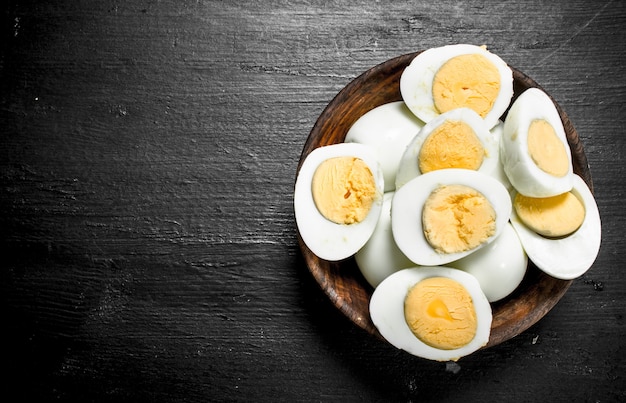 Boiled eggs in a bowl on the black chalkboard