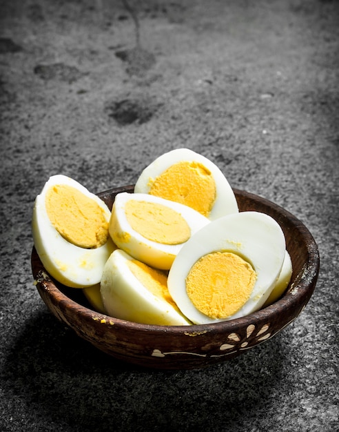 Boiled eggs in a bowl. On a rustic background.