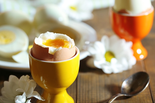 Boiled eggs on color wooden table