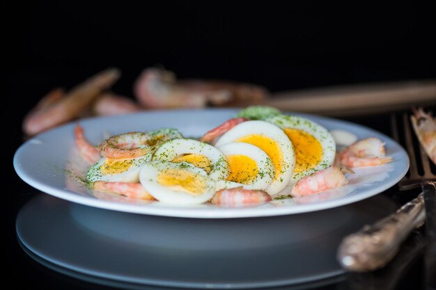 boiled eggs with boiled shrimp in a plate for breakfast