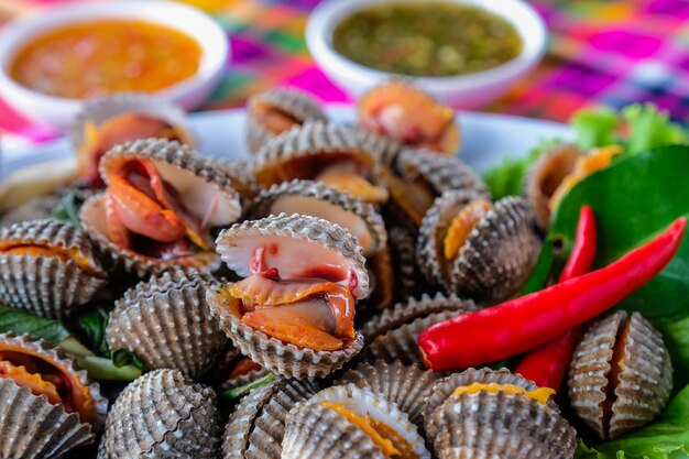 Boiled fresh cockles on lettuce vegetable for seafood serving