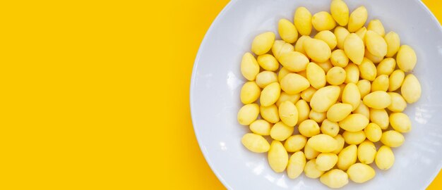 Boiled ginkgo nuts on yellow background