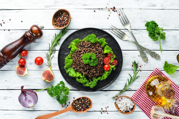 Boiled lentils with vegetables. Dishes menu. Free copy space. Top view.