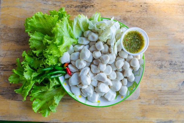 Boiled meatballs eat with spicy seafood sauce. Thai food.