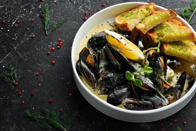 Boiled mussels in cream sauce and garlic Top view Free space for text