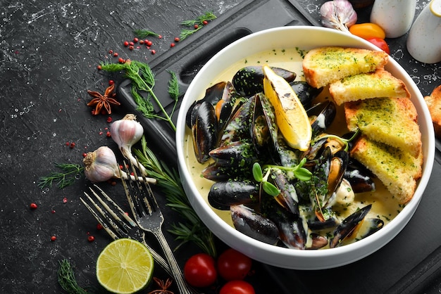 Boiled mussels in cream sauce and garlic Top view Free space for text