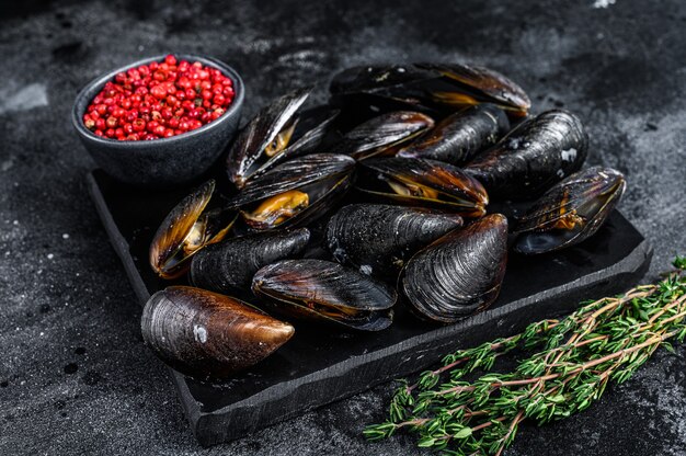 Boiled Mussels in shells on a marble board