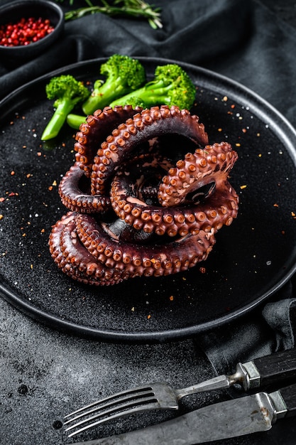 Boiled octopus with broccoli on a plate