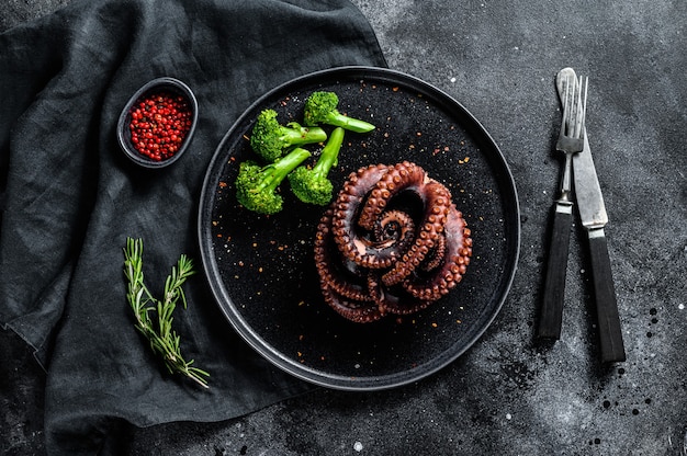 Boiled octopus with broccoli on a plate