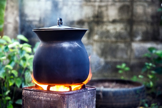 Boiled outdoor iron pot on fire from coal