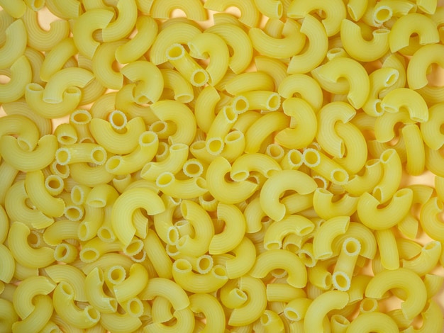 Not boiled pasta on the table Background from pasta