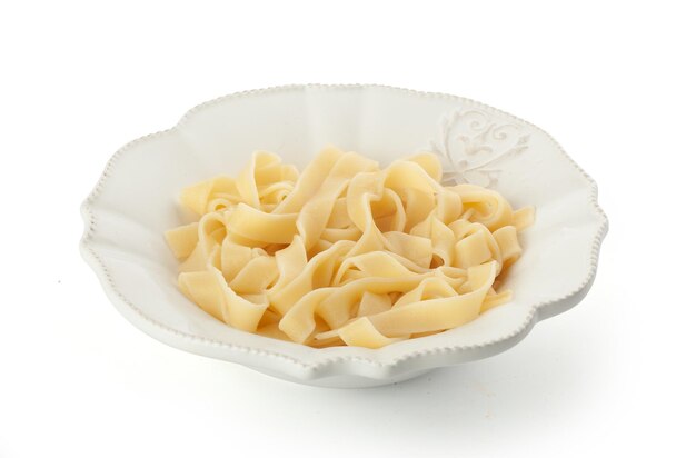 Boiled pasta in the white bowl on the white background