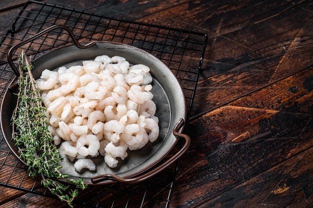Boiled Peeled Shrimps Prawns set Wooden background top view copy space
