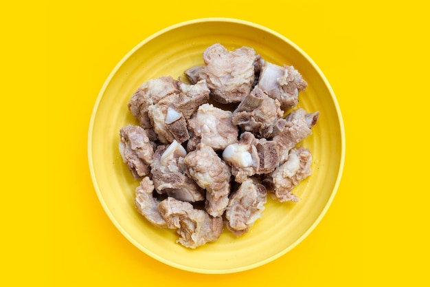 Boiled pork ribs on yellow background