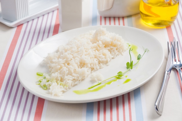 Boiled rice on a white plate in a restaurant