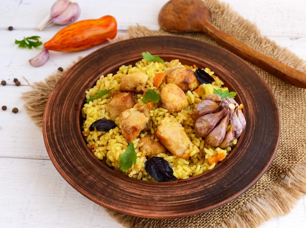 Boiled rice with roasted chicken, carrots, spices (traditional Asian dish - pilaf)