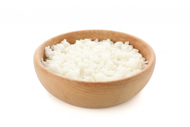 Boiled rice in wooden bowl isolated on white surface