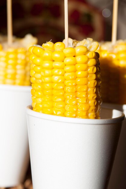 Boiled ripe corn on the cob in a glass