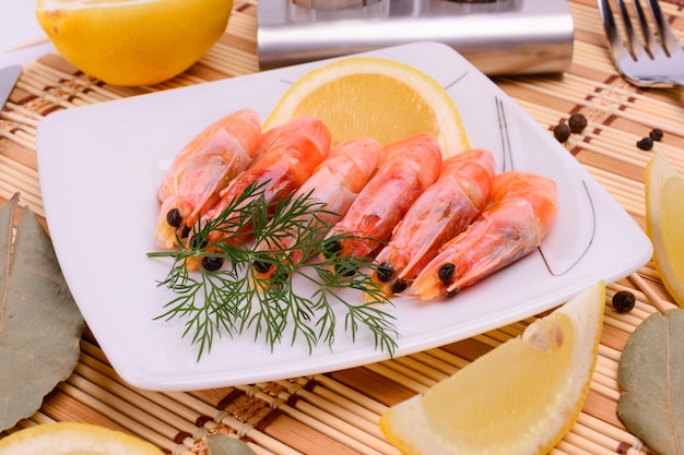 Boiled shrimp on an oval platter.