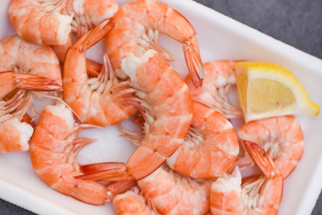 Boiled shrimp prawns cooked food in the seafood restaurant fresh shrimps on on plate plastic tray with lemon