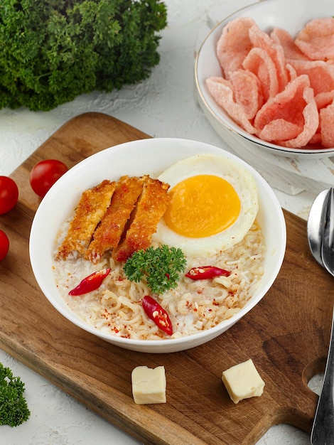 boiled soup with noodles and eggs crisp served in a bowl with chili and celery