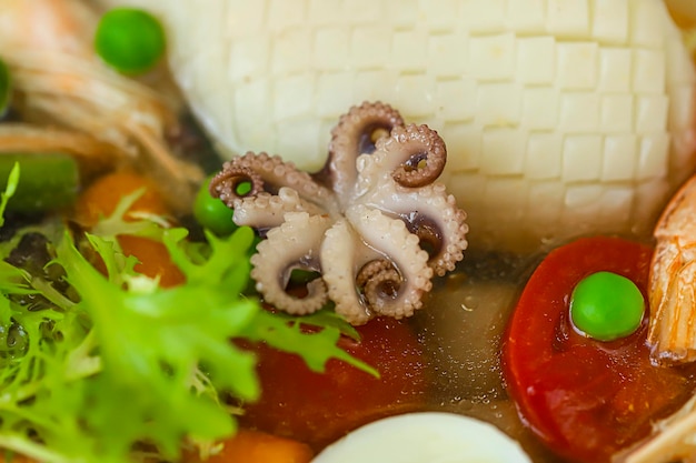 Photo boiled squid with baby carrots and lettuce tomatoes and pea puree keto diet