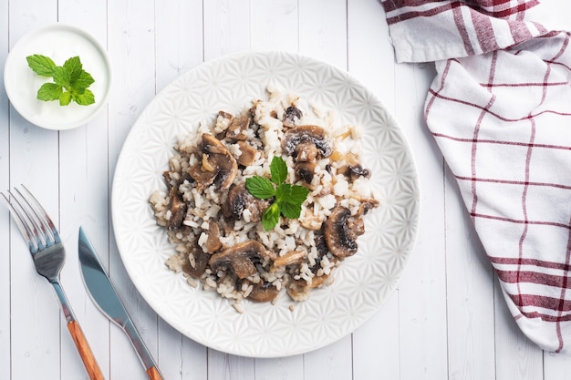 Photo boiled white rice with mushrooms in cream sauce.