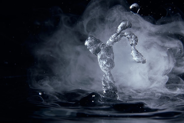 Boiling water splash with steam on black background closeup