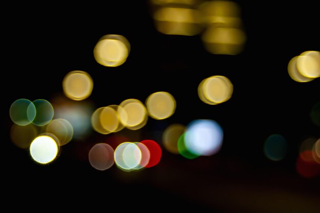 Bokeh of car headlights on the street at night Blurred image of the light of street lamps