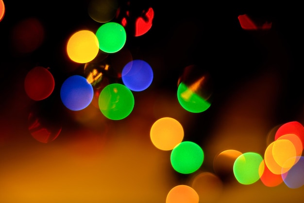 A bokeh in colorful bright green blue and red on a black background