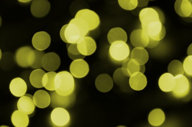 Bokeh effect golden yellow defocused light background. Christmas Lights Concept