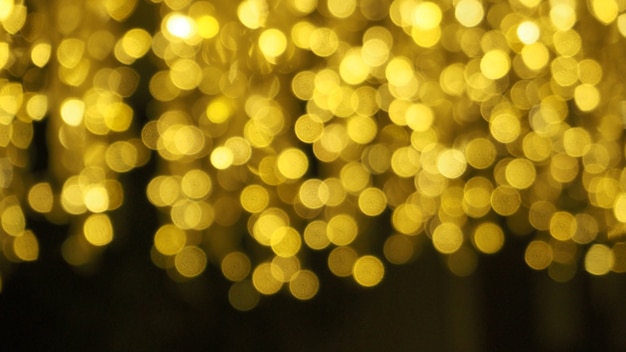 Bokeh images circle bubbles shape yellow color on black background.