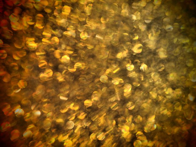 Bokeh light of gold glitters Golden glitter texture background Sparkling glitter wrapping paper with sequins and sparkles Festive golden bokeh and glitter Beautiful macro background