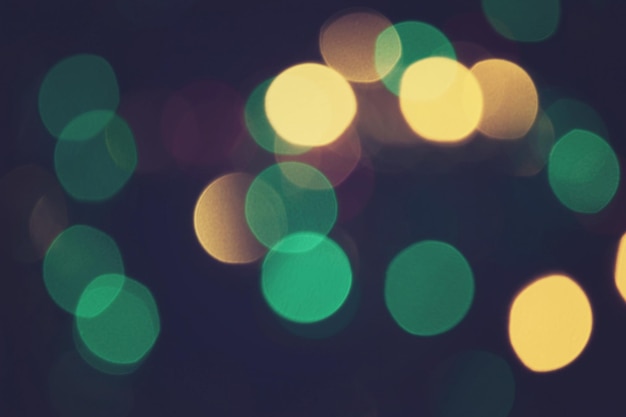 Bokeh lights. Green and gold bokeh circles defocused wallpaper. Holiday bokeh. Christmas. New Year.