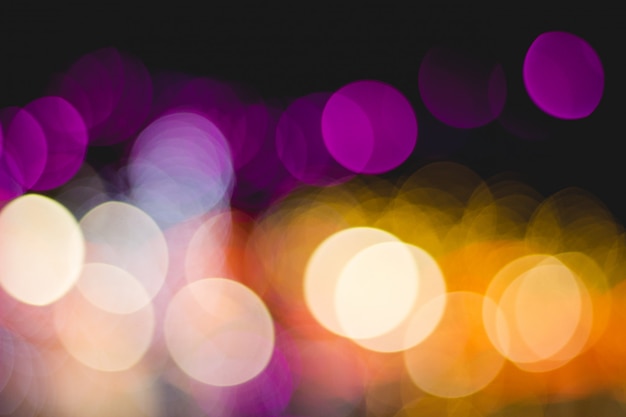 Foto bokeh illumina molti colori su sfondo nero