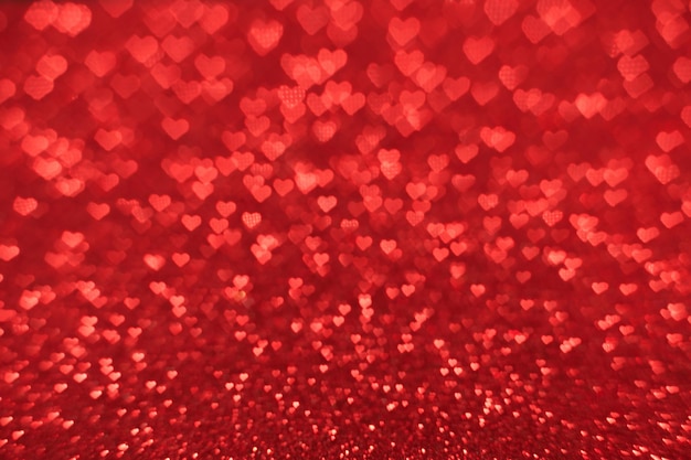 The bokeh texture in the form of many small hearts on a red background