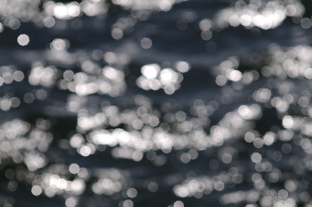 Photo bokeh of water fly and lights on black background