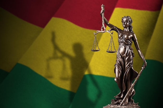 Bolivia flag with statue of lady justice and judicial scales in dark room Concept of judgement and punishment