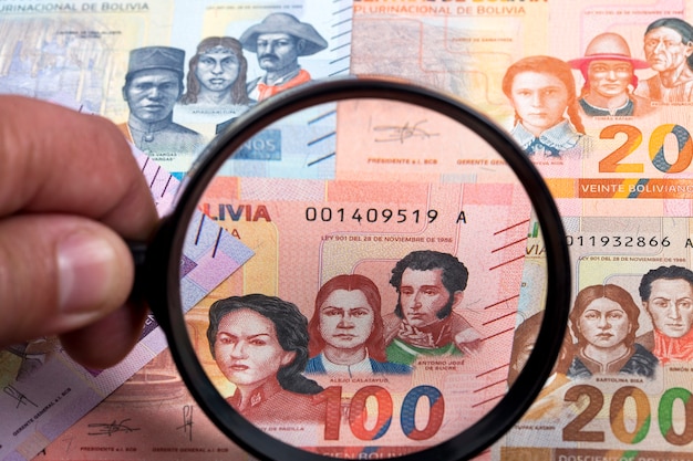 Bolivian money in a magnifying glass a business background