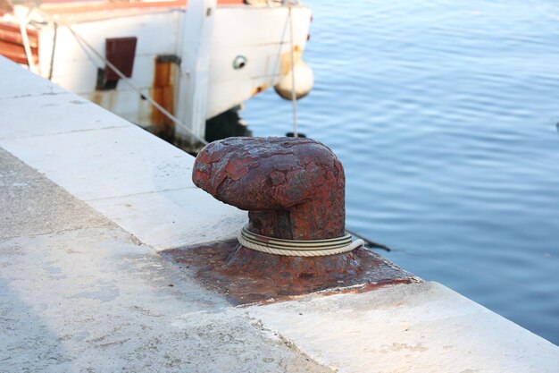 A bollard with a mooring line wrapped around it