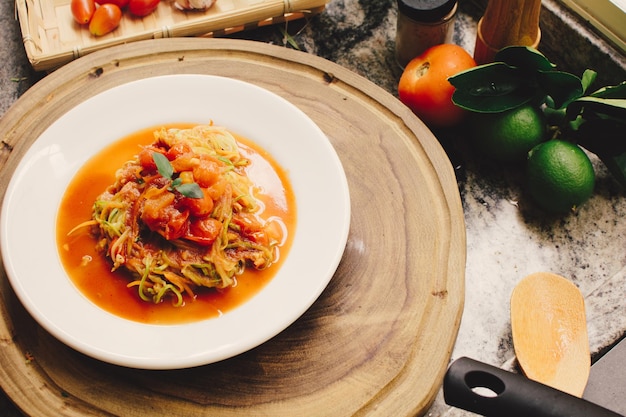 Bolognese pasta dish on a plate photo in a kitchen