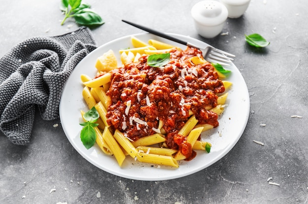 Bolognese penne pasta served on plate