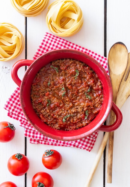 Bolognese sauce on a wooden background Italian cuisine