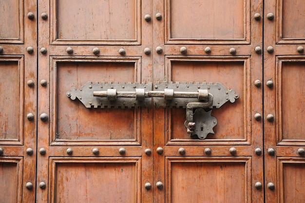 Bolt lock on an old wooden door in Florence Tuscany Italy